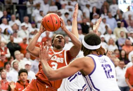 Feb 3, 2024; Fort Worth, Texas, USA;  Texas Longhorns guard Max Abmas (3) shoots as TCU Horned Frogs guard Trevian Tennyson (11) and TCU Horned Frogs forward Xavier Cork (12) defend during the second half at Ed and Rae Schollmaier Arena. Mandatory Credit: Kevin Jairaj-USA TODAY Sports