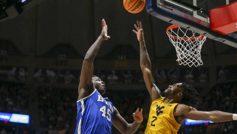 Feb 3, 2024; Morgantown, West Virginia, USA; Brigham Young Cougars forward Fousseyni Traore (45) shoots over West Virginia Mountaineers guard Kobe Johnson (2) during the first half at WVU Coliseum. Mandatory Credit: Ben Queen-USA TODAY Sports