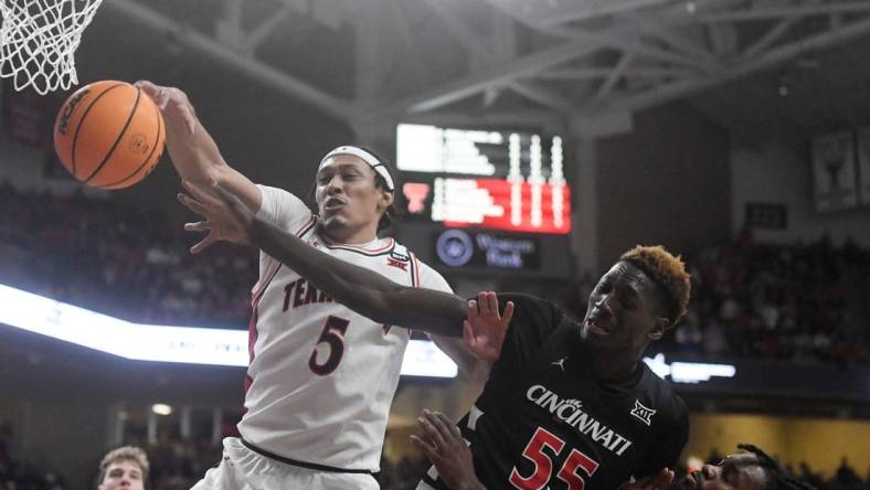 Texas Tech's guard Darrion Williams (5) and Cincinnati's forward Aziz Bandaogo (55) reach for the ball during the Big 12 basketball game, Saturday, Feb. 3, 2024, at United Supermarkets Arena.