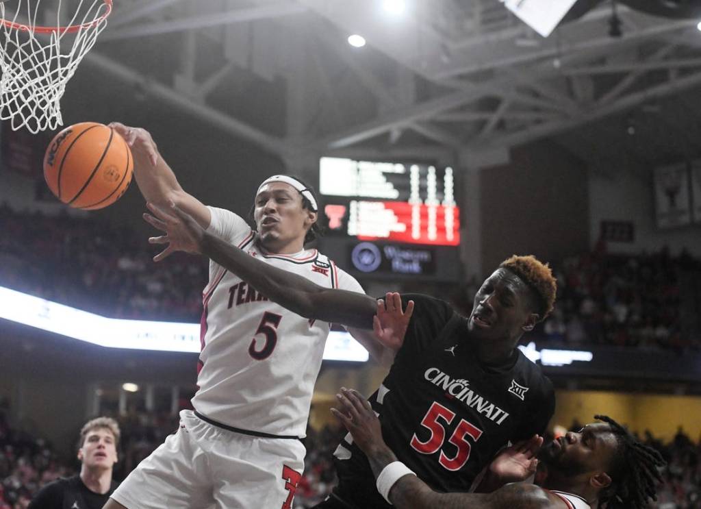 Texas Tech's guard Darrion Williams (5) and Cincinnati's forward Aziz Bandaogo (55) reach for the ball during the Big 12 basketball game, Saturday, Feb. 3, 2024, at United Supermarkets Arena.