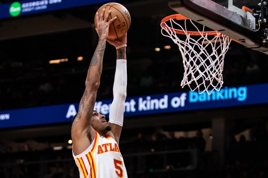 Feb 3, 2024; Atlanta, Georgia, USA; Atlanta Hawks guard Dejounte Murray (5) dunks against Golden State Warriors during the first quarter at State Farm Arena. Mandatory Credit: Jordan Godfree-USA TODAY Sports