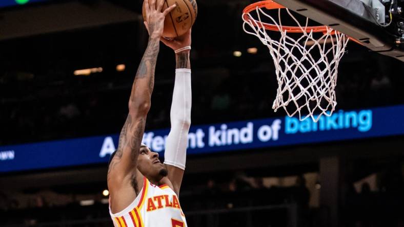 Feb 3, 2024; Atlanta, Georgia, USA; Atlanta Hawks guard Dejounte Murray (5) dunks against Golden State Warriors during the first quarter at State Farm Arena. Mandatory Credit: Jordan Godfree-USA TODAY Sports