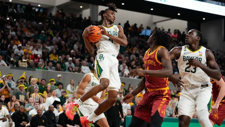 Feb 3, 2024; Waco, Texas, USA; Baylor Bears guard Ja'Kobe Walter (4) grabs a rebound against the Iowa State Cyclones during the first half at Paul and Alejandra Foster Pavilion. Mandatory Credit: Chris Jones-USA TODAY Sports