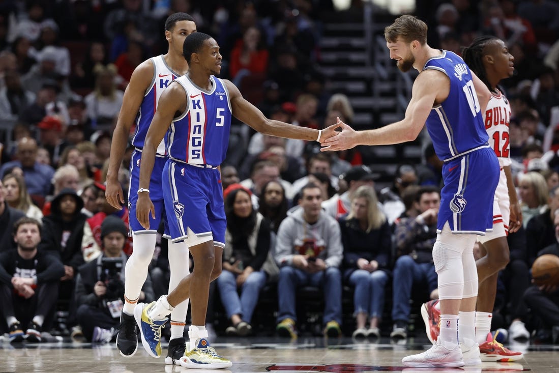 Feb 3, 2024; Chicago, Illinois, USA; Sacramento Kings guard De'Aaron Fox (5) celebrates with forward Domantas Sabonis (10) after scoring against the Chicago Bulls during the first half at United Center. Mandatory Credit: Kamil Krzaczynski-USA TODAY Sports