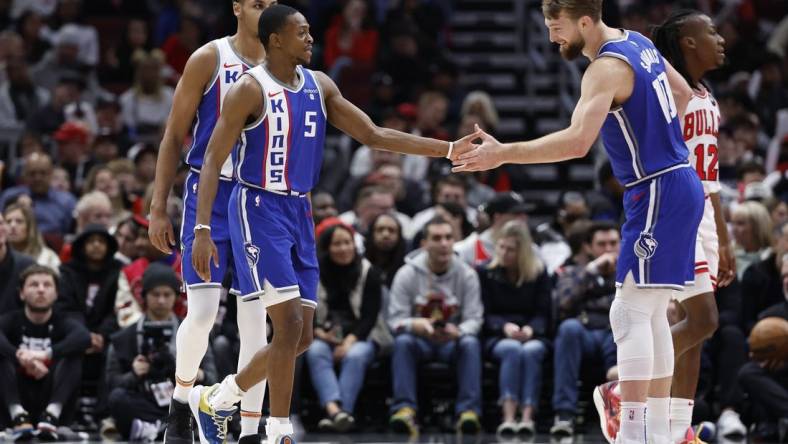 Feb 3, 2024; Chicago, Illinois, USA; Sacramento Kings guard De'Aaron Fox (5) celebrates with forward Domantas Sabonis (10) after scoring against the Chicago Bulls during the first half at United Center. Mandatory Credit: Kamil Krzaczynski-USA TODAY Sports