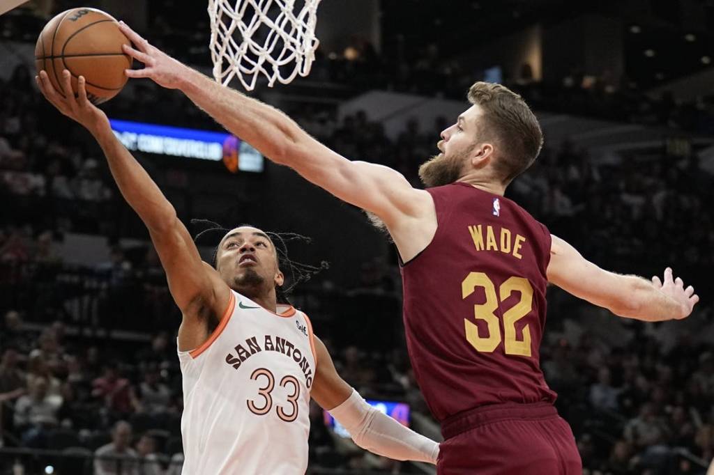 Feb 3, 2024; San Antonio, Texas, USA; Cleveland Cavaliers forward Dean Wade (32) blocks the shot attempted by San Antonio Spurs 33 guard Tre Jones (33) during the first half at Frost Bank Center. Mandatory Credit: Scott Wachter-USA TODAY Sports