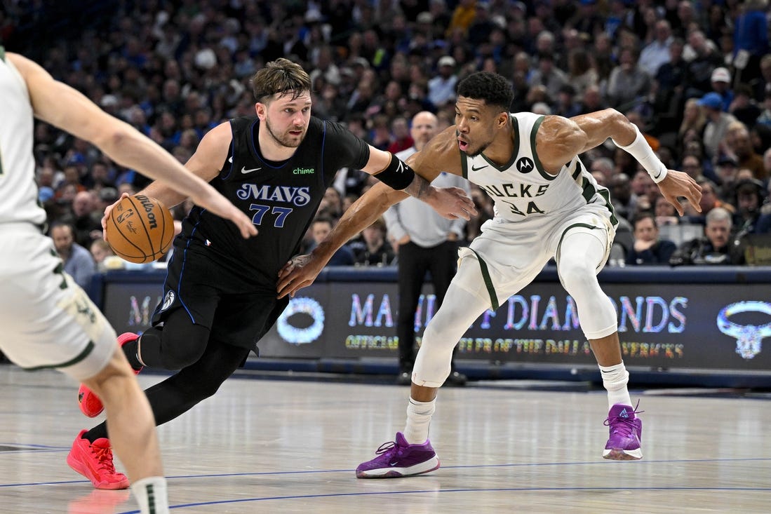 Feb 3, 2024; Dallas, Texas, USA; Dallas Mavericks guard Luka Doncic (77) drives to the basket past Milwaukee Bucks forward Giannis Antetokounmpo (34) during the second quarter at the American Airlines Center. Mandatory Credit: Jerome Miron-USA TODAY Sports