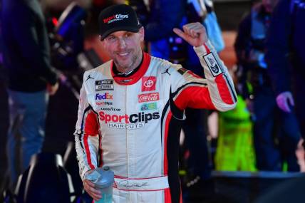 Feb 3, 2024; Los Angeles, California, USA;  NASCAR Cup Series driver Denny Hamlin (11) celebrates his victory of the Busch Light Clash at Los Angeles Memorial Coliseum. Mandatory Credit: Gary A. Vasquez-USA TODAY Sports