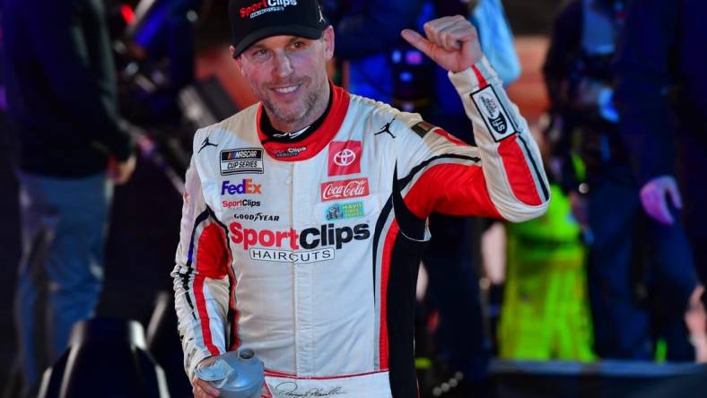 Feb 3, 2024; Los Angeles, California, USA;  NASCAR Cup Series driver Denny Hamlin (11) celebrates his victory of the Busch Light Clash at Los Angeles Memorial Coliseum. Mandatory Credit: Gary A. Vasquez-USA TODAY Sports