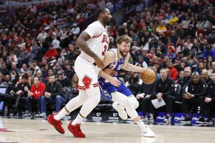 Feb 3, 2024; Chicago, Illinois, USA; Sacramento Kings forward Domantas Sabonis (10) drives to the basket against Chicago Bulls center Andre Drummond (3) during the second half at United Center. Mandatory Credit: Kamil Krzaczynski-USA TODAY Sports