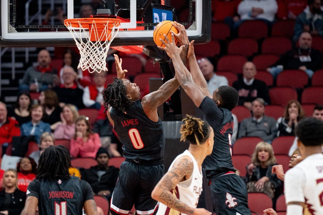 Louisville Cardinals forward Brandon Huntley-Hatfield (5) and Mike James (0) grab the rebound during their game against the Florida State Seminoles on Saturday, Feb. 3, 2024 at KFC YUM Center.