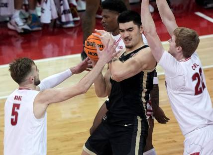 Feb 4, 2024; Madison, Wisconsin, USA; Purdue   s Zach Edey (15) is swamped by Wisconsin forward Tyler Wahl (5) and forward Steven Crowl (22) during the first half at Kohl Center. Mandatory Credit: Kayla Wolf-USA TODAY Sports