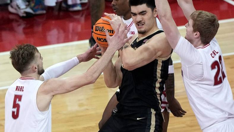 Purdue center Zach Edey is swamped by Wisconsin forwards Tyler Wahl (5) and Steven Crowl during the first half Sunday at the Kohl Center.Mark Hoffman/Milwaukee Journal Sentinel