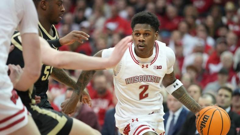 Feb 4, 2024; Madison, Wisconsin, USA; Wisconsin Badgers guard AJ Storr (2) dribbles the ball against Purdue Boilermakers guard Lance Jones (55) during the second half at the Kohl Center. Mandatory Credit: Kayla Wolf-USA TODAY Sports