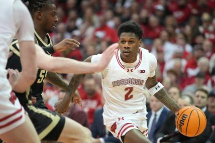 Feb 4, 2024; Madison, Wisconsin, USA; Wisconsin Badgers guard AJ Storr (2) dribbles the ball against Purdue Boilermakers guard Lance Jones (55) during the second half at the Kohl Center. Mandatory Credit: Kayla Wolf-USA TODAY Sports