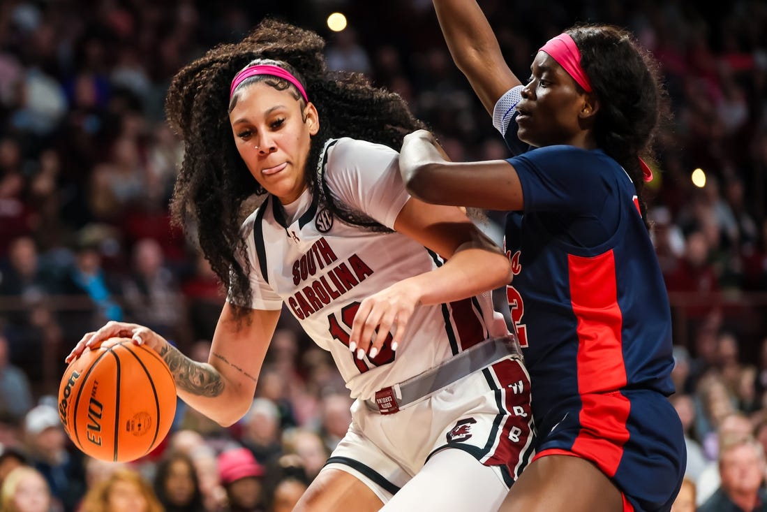 Feb 4, 2024; Columbia, South Carolina, USA; South Carolina Gamecocks center Kamilla Cardoso (10) dribbles around Ole Miss Rebels center Rita Igbokwe (32) in the first half at Colonial Life Arena. Mandatory Credit: Jeff Blake-USA TODAY Sports