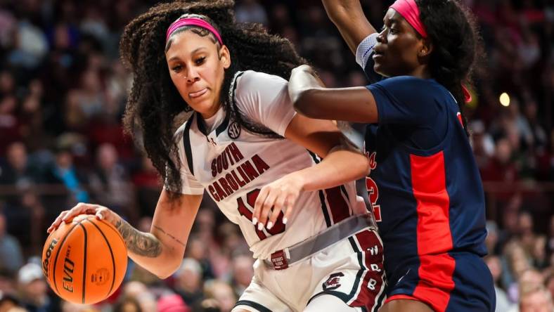 Feb 4, 2024; Columbia, South Carolina, USA; South Carolina Gamecocks center Kamilla Cardoso (10) dribbles around Ole Miss Rebels center Rita Igbokwe (32) in the first half at Colonial Life Arena. Mandatory Credit: Jeff Blake-USA TODAY Sports