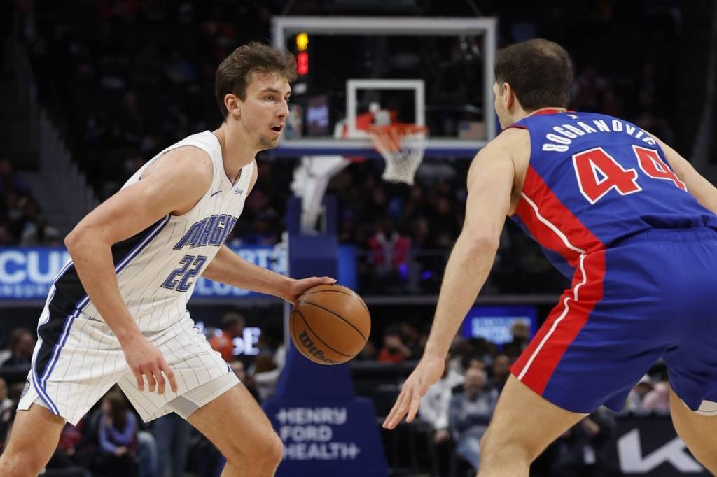 Feb 4, 2024; Detroit, Michigan, USA; Orlando Magic forward Franz Wagner (22) is defended by Detroit Pistons forward Bojan Bogdanovic (44) in the first half at Little Caesars Arena. Mandatory Credit: Rick Osentoski-USA TODAY Sports