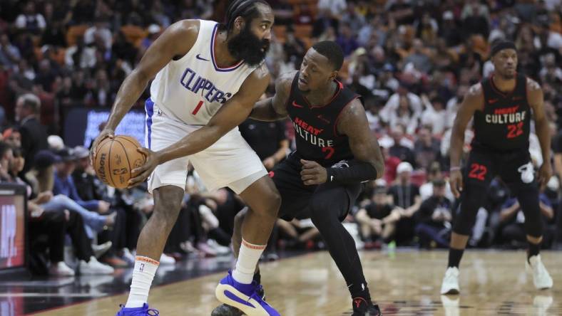 Feb 4, 2024; Miami, Florida, USA; LA Clippers guard James Harden (1) protects the basketball from Miami Heat guard Terry Rozier (2) during the first quarter at Kaseya Center. Mandatory Credit: Sam Navarro-USA TODAY Sports