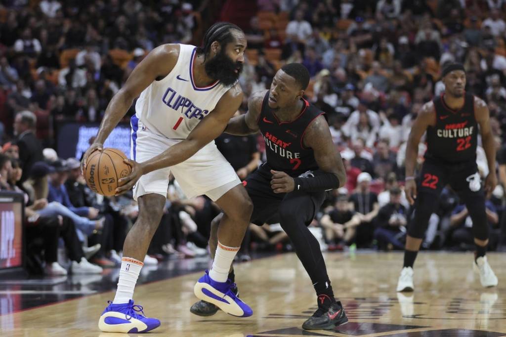 Feb 4, 2024; Miami, Florida, USA; LA Clippers guard James Harden (1) protects the basketball from Miami Heat guard Terry Rozier (2) during the first quarter at Kaseya Center. Mandatory Credit: Sam Navarro-USA TODAY Sports