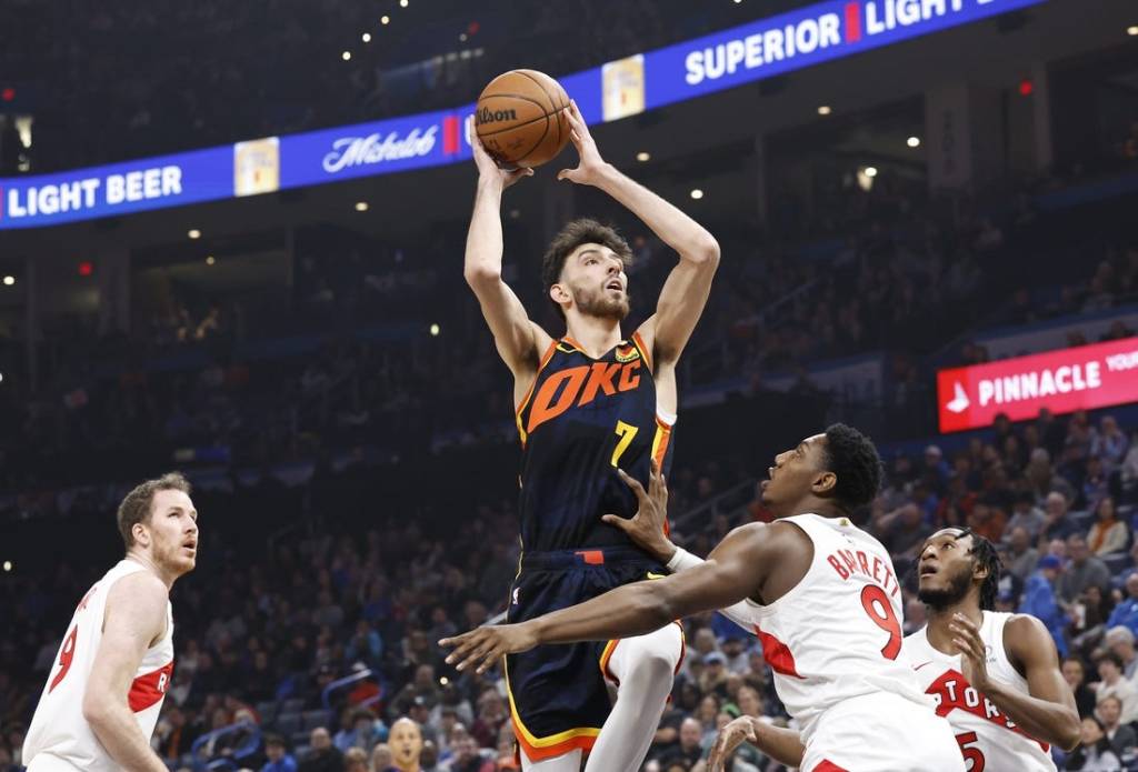 Feb 4, 2024; Oklahoma City, Oklahoma, USA; Oklahoma City Thunder forward Chet Holmgren (7) shoots against Toronto Raptors guard RJ Barrett (9) during the first quarter at Paycom Center. Mandatory Credit: Alonzo Adams-USA TODAY Sports