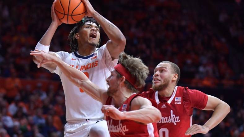 Feb 4, 2024; Champaign, Illinois, USA;  Illinois Fighting Illini guard Terrence Shannon Jr. (0) drives to the basket against Nebraska Cornhuskers guard Sam Hoiberg (1) during the first half at State Farm Center. Mandatory Credit: Ron Johnson-USA TODAY Sports