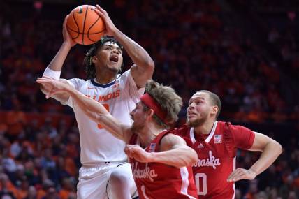 Feb 4, 2024; Champaign, Illinois, USA;  Illinois Fighting Illini guard Terrence Shannon Jr. (0) drives to the basket against Nebraska Cornhuskers guard Sam Hoiberg (1) during the first half at State Farm Center. Mandatory Credit: Ron Johnson-USA TODAY Sports