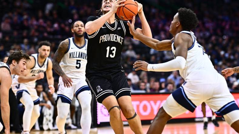 Feb 4, 2024; Philadelphia, Pennsylvania, USA; Providence Friars forward Josh Oduro (13) drives against Villanova Wildcats guard Jordan Longino (15) in the first half at Wells Fargo Center. Mandatory Credit: Kyle Ross-USA TODAY Sports