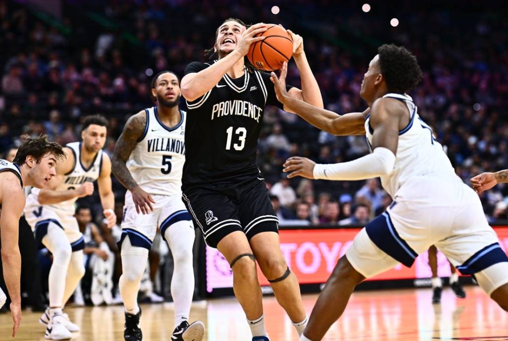 Feb 4, 2024; Philadelphia, Pennsylvania, USA; Providence Friars forward Josh Oduro (13) drives against Villanova Wildcats guard Jordan Longino (15) in the first half at Wells Fargo Center. Mandatory Credit: Kyle Ross-USA TODAY Sports