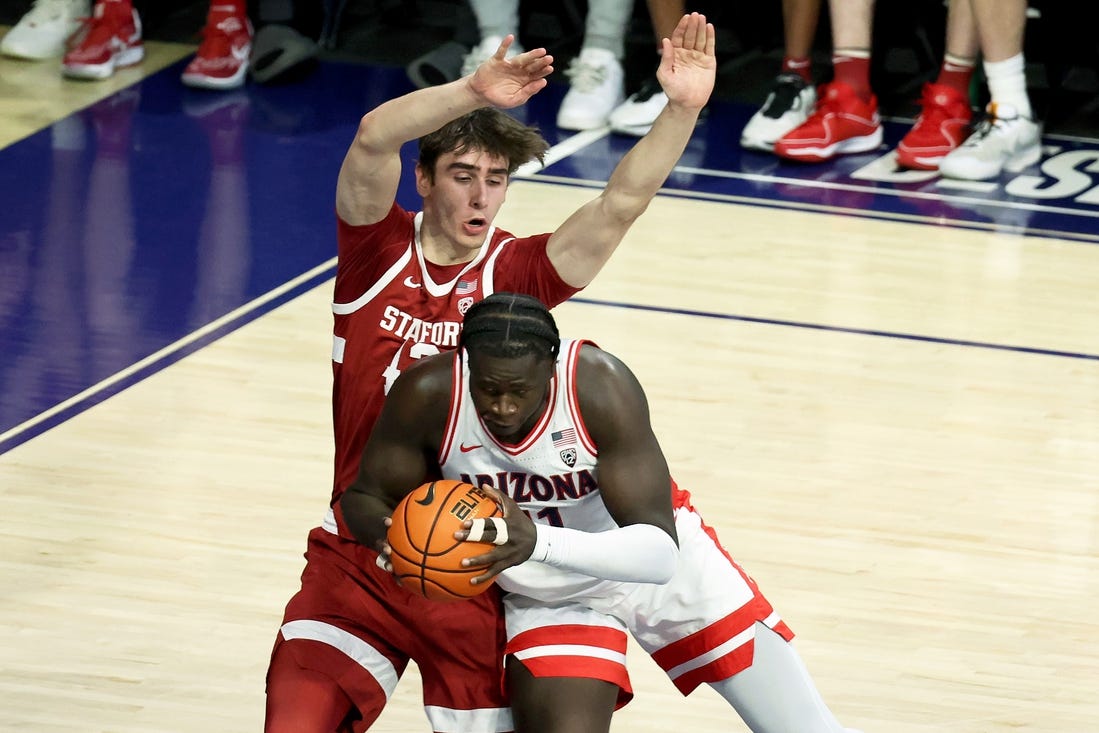 Feb 4, 2024; Tucson, Arizona, USA; Arizona Wildcats center Oumar Ballo (11) drives to the net against Stanford Cardinal forward Maxime Raynaud (42) during the first half at McKale Center. Mandatory Credit: Zachary BonDurant-USA TODAY Sports