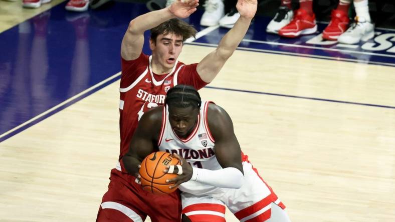 Feb 4, 2024; Tucson, Arizona, USA; Arizona Wildcats center Oumar Ballo (11) drives to the net against Stanford Cardinal forward Maxime Raynaud (42) during the first half at McKale Center. Mandatory Credit: Zachary BonDurant-USA TODAY Sports