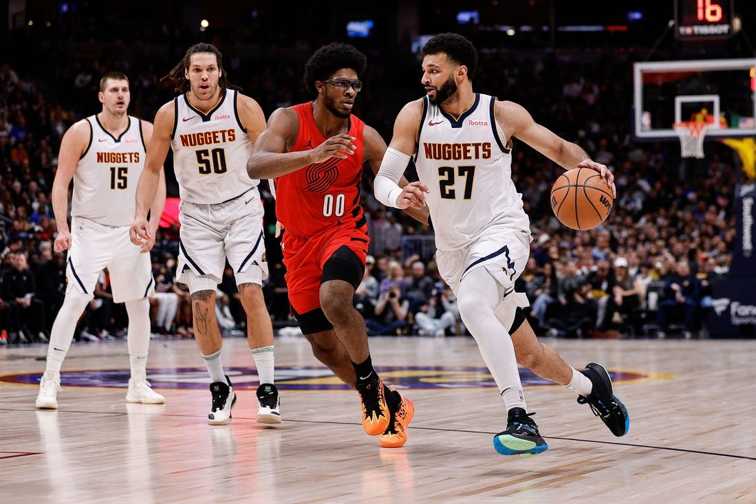 Feb 4, 2024; Denver, Colorado, USA; Denver Nuggets guard Jamal Murray (27) controls the ball against Portland Trail Blazers guard Scoot Henderson (00) as forward Aaron Gordon (50) and center Nikola Jokic (15) defend in the second quarter at Ball Arena. Mandatory Credit: Isaiah J. Downing-USA TODAY Sports