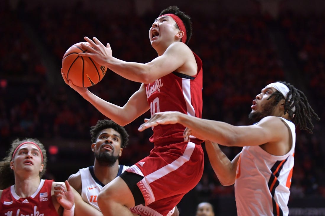 Feb 4, 2024; Champaign, Illinois, USA;  Nebraska Cornhuskers guard Keisei Tominaga (30) drives past Illinois Fighting Illini forward Ty Rodgers (20) during the second half at State Farm Center. Mandatory Credit: Ron Johnson-USA TODAY Sports