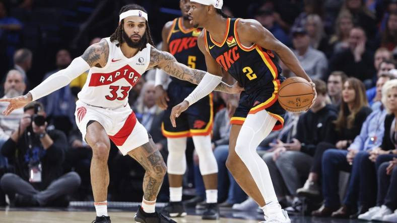 Feb 4, 2024; Oklahoma City, Oklahoma, USA; Oklahoma City Thunder guard Shai Gilgeous-Alexander (2) moves the ball against Toronto Raptors guard Gary Trent Jr. (33) during the second half at Paycom Center. Mandatory Credit: Alonzo Adams-USA TODAY Sports