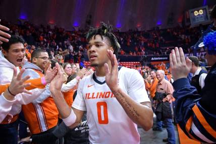 Feb 4, 2024; Champaign, Illinois, USA;  Illinois Fighting Illini forward Ty Rodgers (20) gets a hand from the fans after a 87-84 win over the Nebraska Cornhuskers at State Farm Center. Mandatory Credit: Ron Johnson-USA TODAY Sports