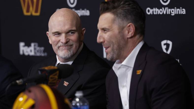 Feb 5, 2024; Ashburn, VA, USA; Washington Commanders head coach Dan Quinn (L) smiles as Commanders general manager Adam Peters (R) speaks during Quinn's introductory press conference at Commanders Park. Mandatory Credit: Geoff Burke-USA TODAY Sports