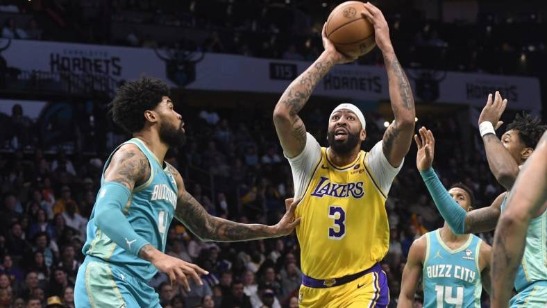 Feb 5, 2024; Charlotte, North Carolina, USA;  Los Angeles Lakers forward Anthony Davis (3) looks to pass as he is defended by Charlotte Hornets center Nick Richards (4) during the first half at the Spectrum Center. Mandatory Credit: Sam Sharpe-USA TODAY Sports