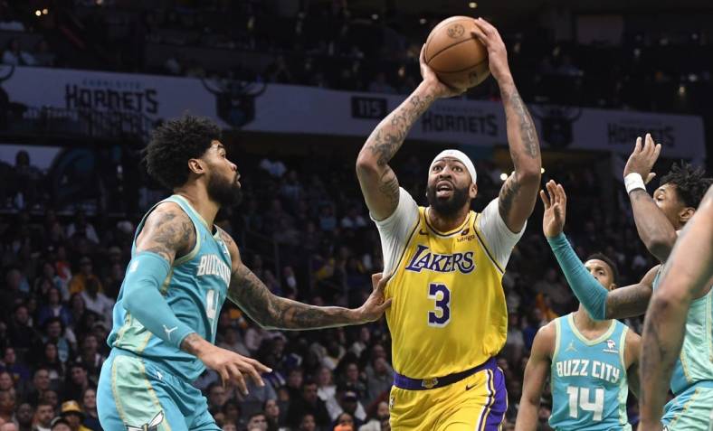 Feb 5, 2024; Charlotte, North Carolina, USA;  Los Angeles Lakers forward Anthony Davis (3) looks to pass as he is defended by Charlotte Hornets center Nick Richards (4) during the first half at the Spectrum Center. Mandatory Credit: Sam Sharpe-USA TODAY Sports
