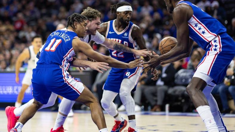 Feb 5, 2024; Philadelphia, Pennsylvania, USA; Dallas Mavericks guard Luka Doncic (77) and Philadelphia 76ers guard Jaden Springer (11) and guard Patrick Beverley (22) chase a loose ball during the second quarter at Wells Fargo Center. Mandatory Credit: Bill Streicher-USA TODAY Sports