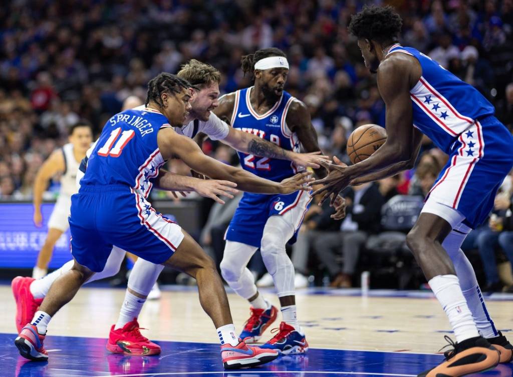 Feb 5, 2024; Philadelphia, Pennsylvania, USA; Dallas Mavericks guard Luka Doncic (77) and Philadelphia 76ers guard Jaden Springer (11) and guard Patrick Beverley (22) chase a loose ball during the second quarter at Wells Fargo Center. Mandatory Credit: Bill Streicher-USA TODAY Sports