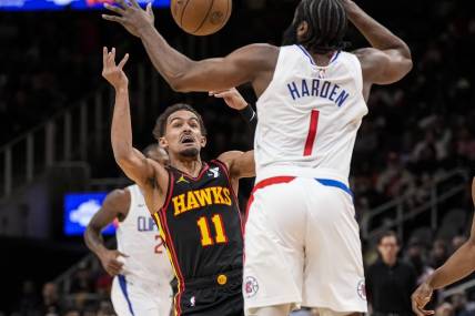Feb 5, 2024; Atlanta, Georgia, USA; Atlanta Hawks guard Trae Young (11) looses the ball against LA Clippers guard James Harden (1) during the first half at State Farm Arena. Mandatory Credit: Dale Zanine-USA TODAY Sports