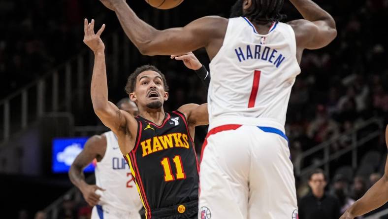 Feb 5, 2024; Atlanta, Georgia, USA; Atlanta Hawks guard Trae Young (11) looses the ball against LA Clippers guard James Harden (1) during the first half at State Farm Arena. Mandatory Credit: Dale Zanine-USA TODAY Sports