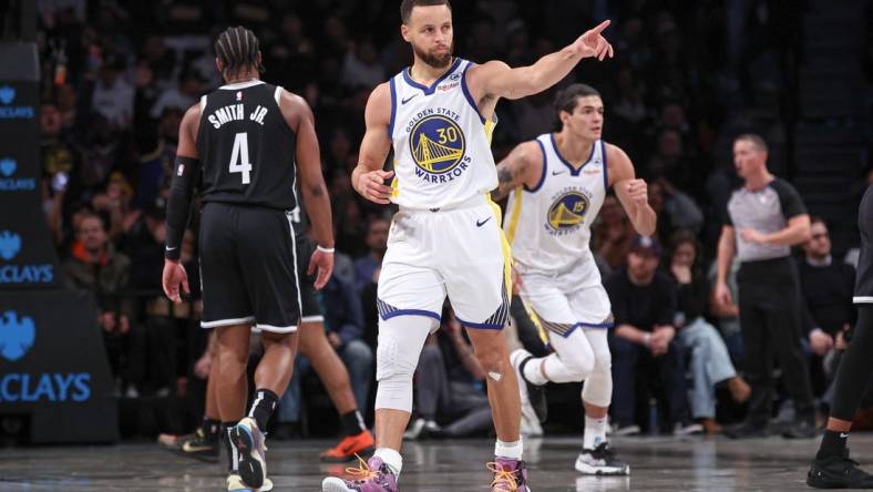 Feb 5, 2024; Brooklyn, New York, USA; Golden State Warriors guard Stephen Curry (30) reacts after making a three point basket during the first half against the Brooklyn Nets at Barclays Center. Mandatory Credit: Vincent Carchietta-USA TODAY Sports