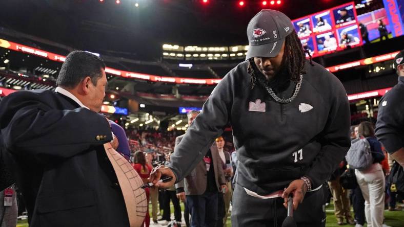 Feb 5, 2024; Las Vegas, NV, USA; Kansas City Chiefs offensive tackle Lucas Niang (77) draws on the stomach of Guillermo Rodriguez Super Bowl LVIII Opening Night at Allegiant Stadium. Mandatory Credit: Lucas Peltier-USA TODAY Sports