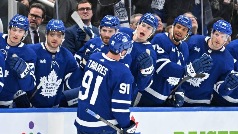 Feb 5, 2024; Toronto, Ontario, CAN;   Toronto Maple Leafs forward John Tavares (91) celebrates with team mates at the bench after scoring a goal against the New York Islanders in the third period at Scotiabank Arena. Mandatory Credit: Dan Hamilton-USA TODAY Sports