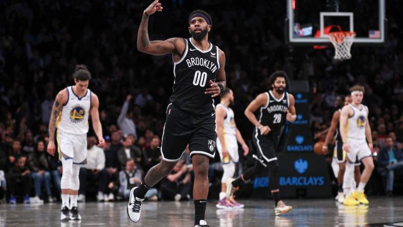 Feb 5, 2024; Brooklyn, New York, USA; Brooklyn Nets forward Royce O'Neale (00) reacts after making a three point basket during the second half against the Golden State Warriors at Barclays Center. Mandatory Credit: Vincent Carchietta-USA TODAY Sports