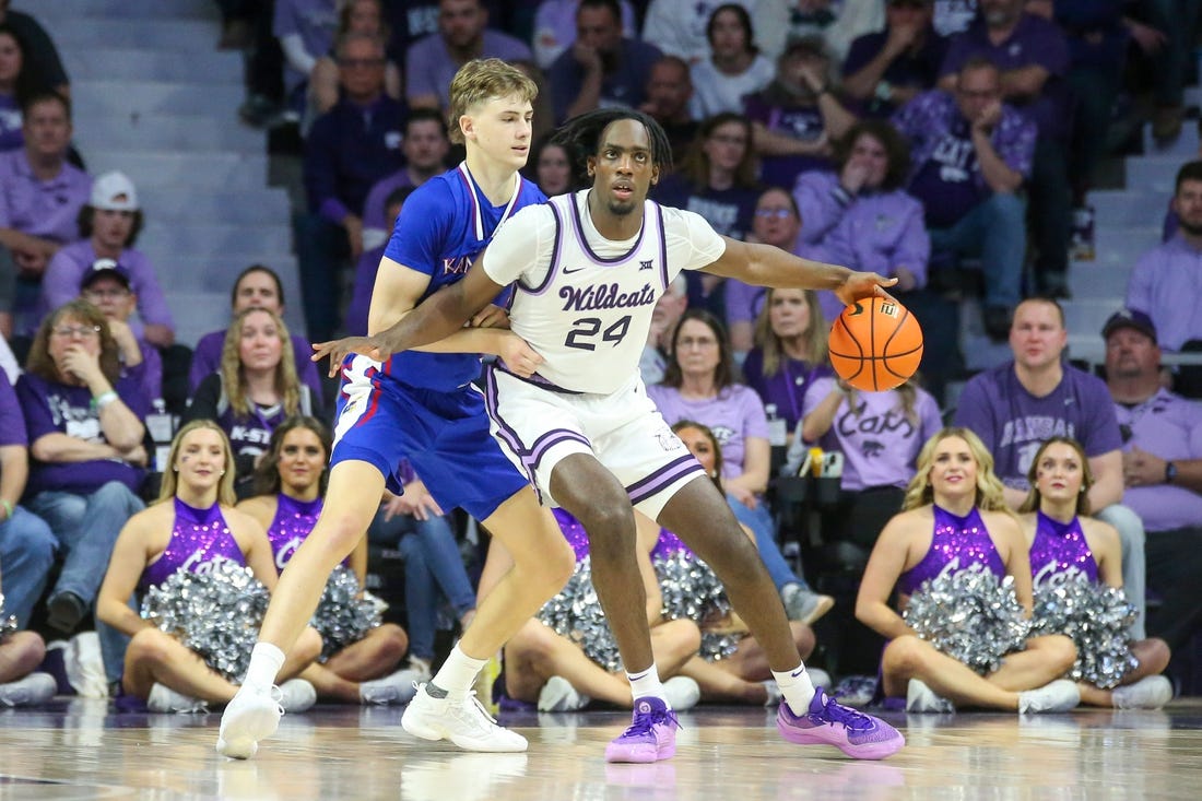 Feb 5, 2024; Manhattan, Kansas, USA; Kansas State Wildcats forward Arthur Maluma (24) is guarded by Kansas Jayhawks guard Johnny Furphy (10) during the second half at Bramlage Coliseum. Mandatory Credit: Scott Sewell-USA TODAY Sports