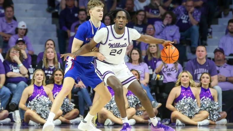 Feb 5, 2024; Manhattan, Kansas, USA; Kansas State Wildcats forward Arthur Maluma (24) is guarded by Kansas Jayhawks guard Johnny Furphy (10) during the second half at Bramlage Coliseum. Mandatory Credit: Scott Sewell-USA TODAY Sports