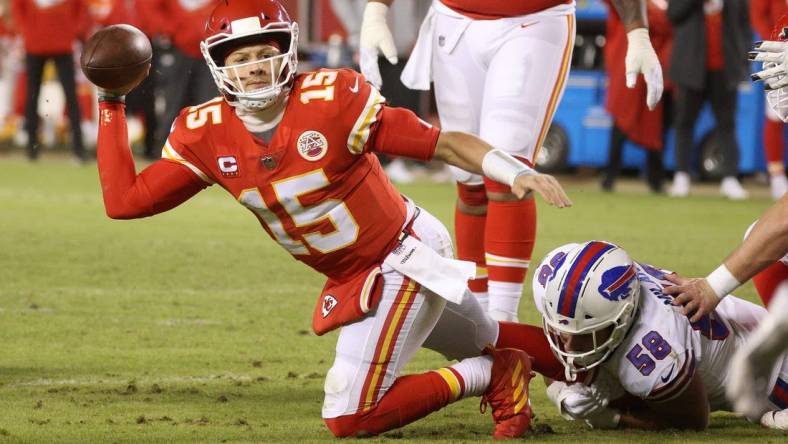 Chiefs quarterback Patrick Mahomes tries to make a throw as his is hit by Bills Matt Milano.