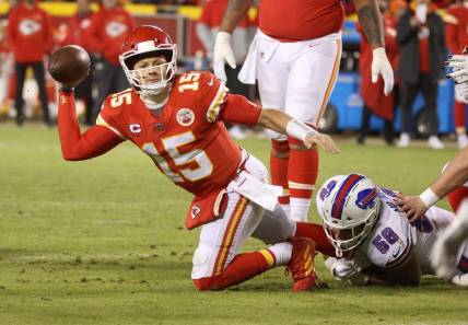Chiefs quarterback Patrick Mahomes tries to make a throw as his is hit by Bills Matt Milano.